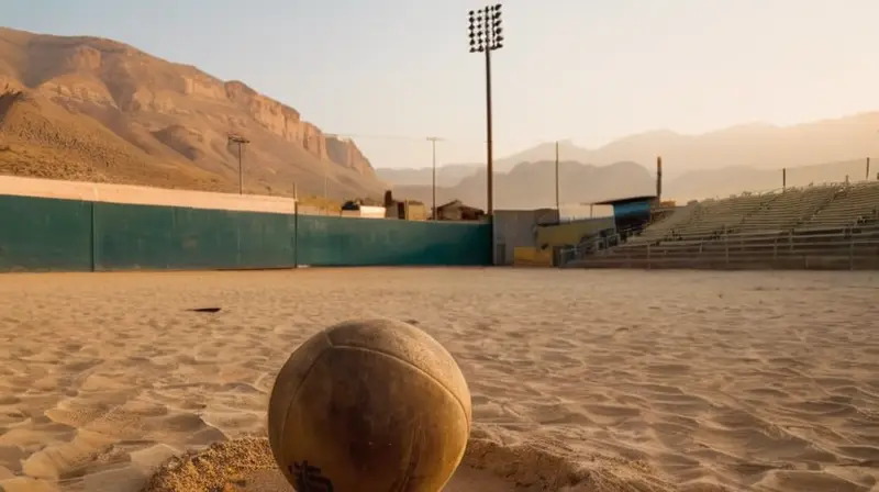 Un jugador de fútbol, agotado y determinado, corre a través del estadio vacío con una pelota en la mano, rodeado por las sombras extendidas bajo el cielo dorado del atardecer